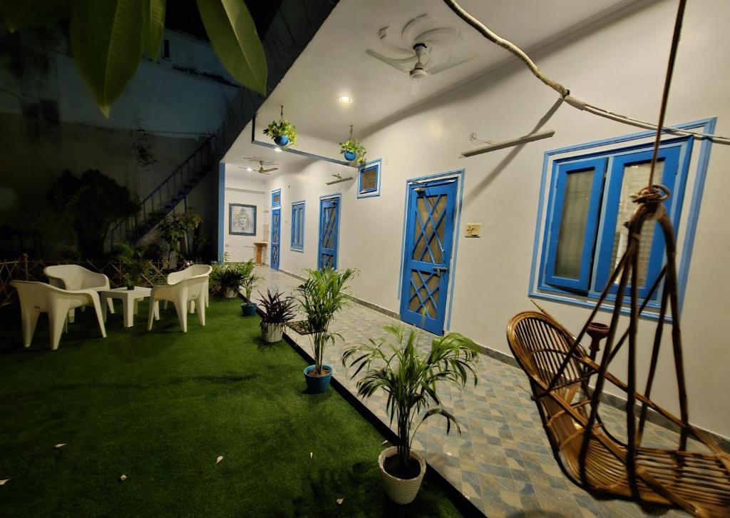 a room with a yard with chairs and a blue door at Sunlit stays-Forest view in Lucknow