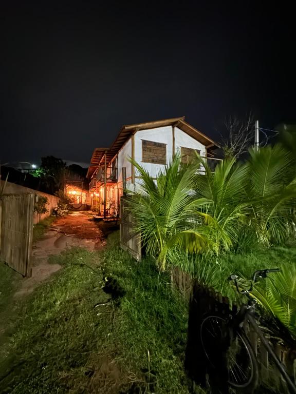a house is lit up at night at Pousada Reserva Setiba Guarapari in Guarapari