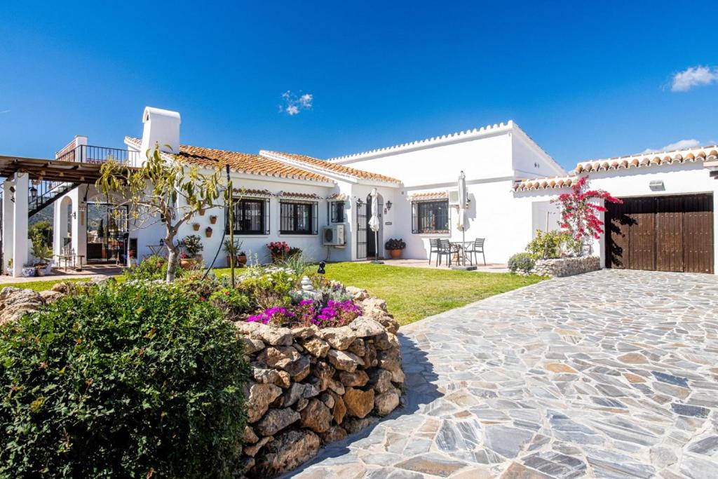a white house with a stone driveway at villa larwik frigiliana in Frigiliana