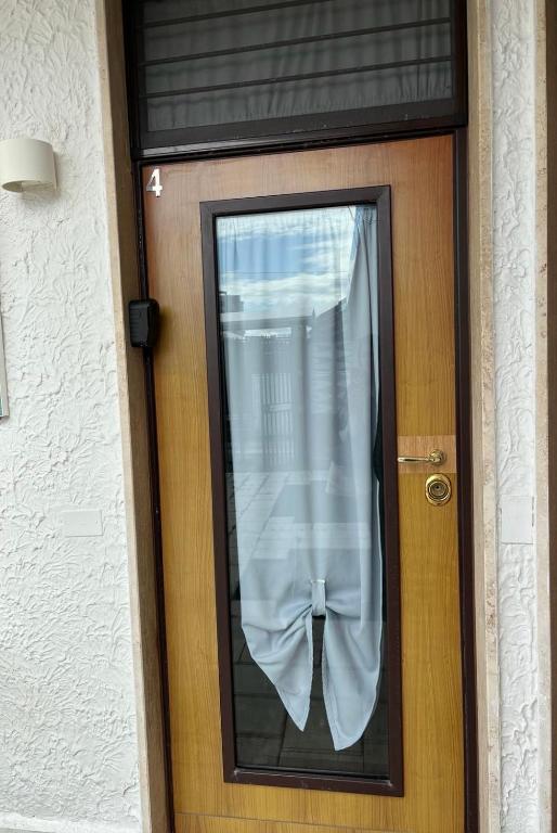 a door with a window with a curtain on it at Truly Apulia in Bari