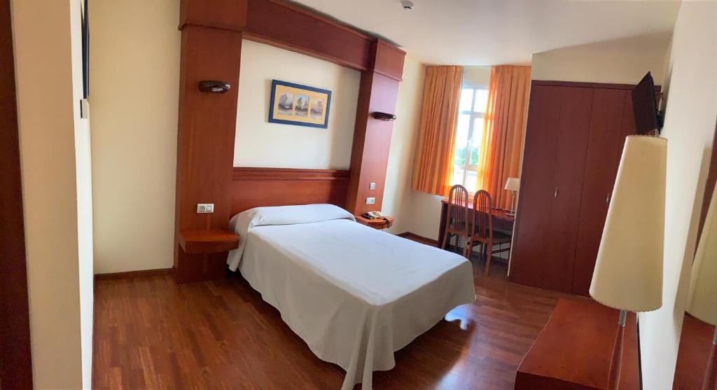 Postel nebo postele na pokoji v ubytování Hotel Barreiro