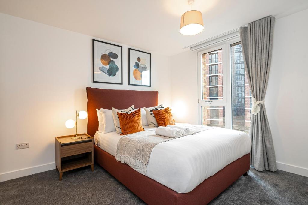 a bedroom with a large bed and a window at Monk Bridge Viaduct in Leeds