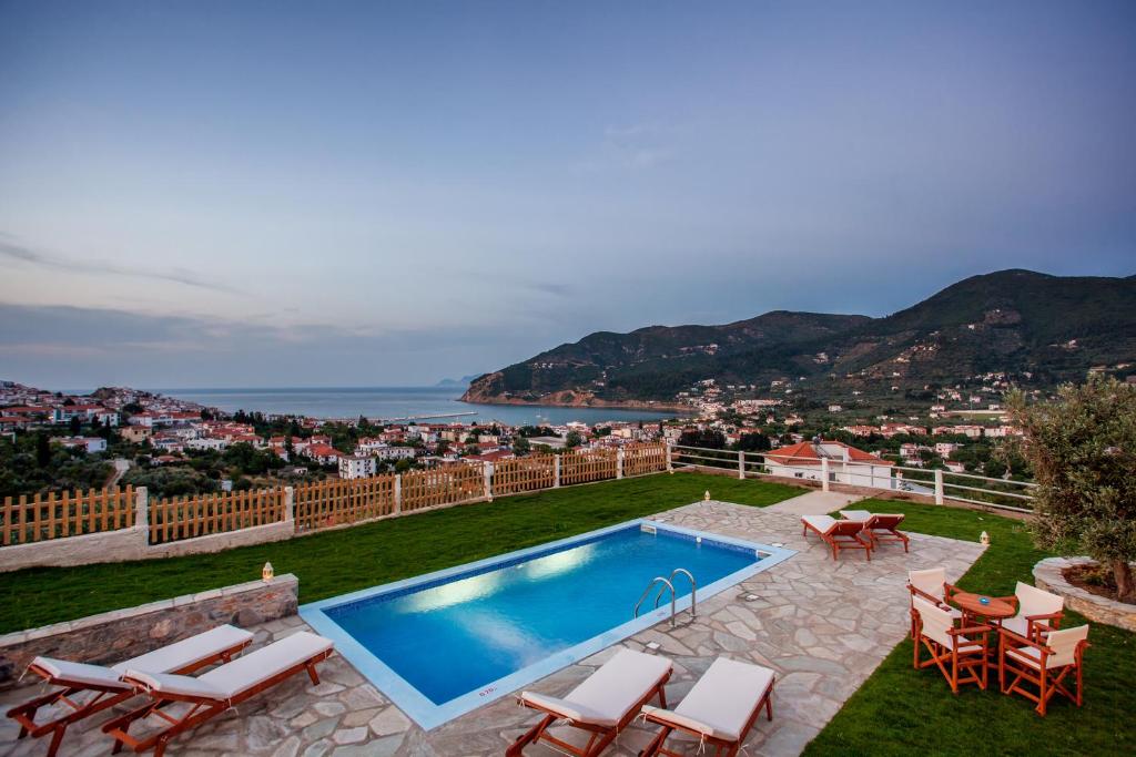 a villa with a swimming pool and a view at Villa Anatoli in Skopelos Town
