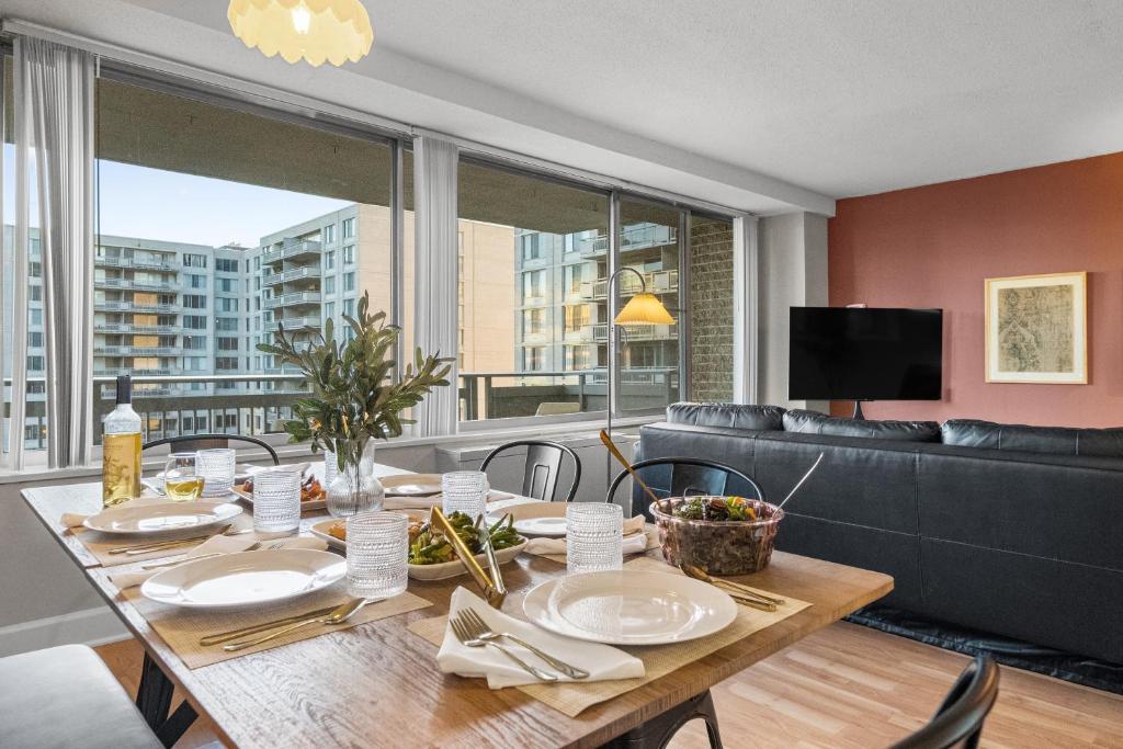 a dining room with a table and a couch at DC Luxury Apartment Near Metro in Arlington