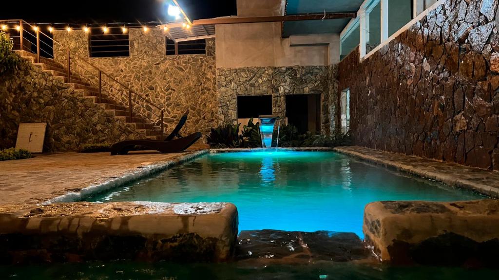 a swimming pool in a house at night at Termales la Montaña - Hot Springs in Ahuachapán