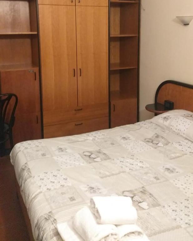 Łóżko lub łóżka w pokoju w obiekcie LH Albergo il Picchio