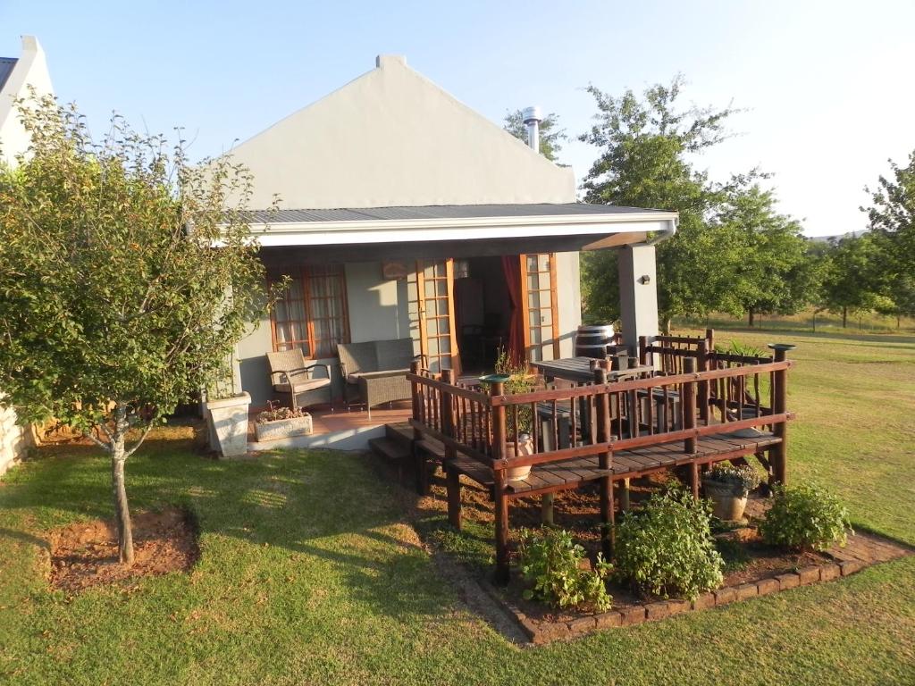 a house with a porch with a deck at J&B Lodge in Underberg