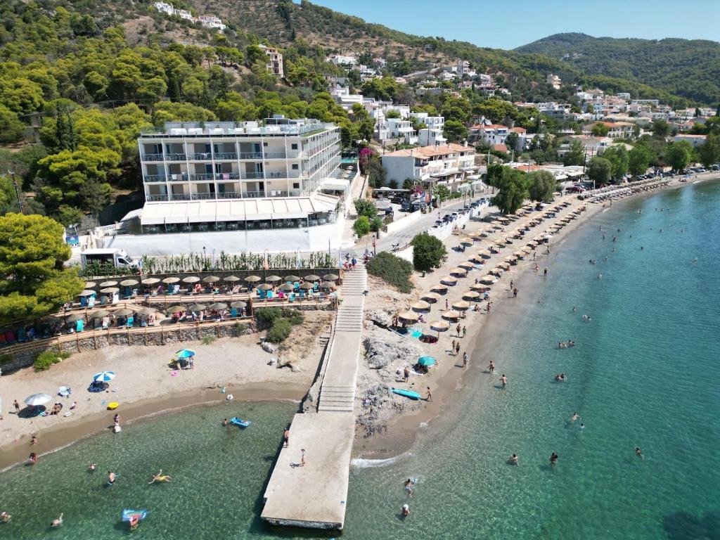an aerial view of a beach with people in the water at New Aegli Resort Hotel in Poros