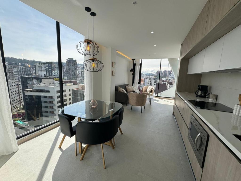 キトにあるSuite Moderna en La Carolina Vista Panoramica Pisicna Amenitiesのキッチン、市街の景色を望むダイニングルーム