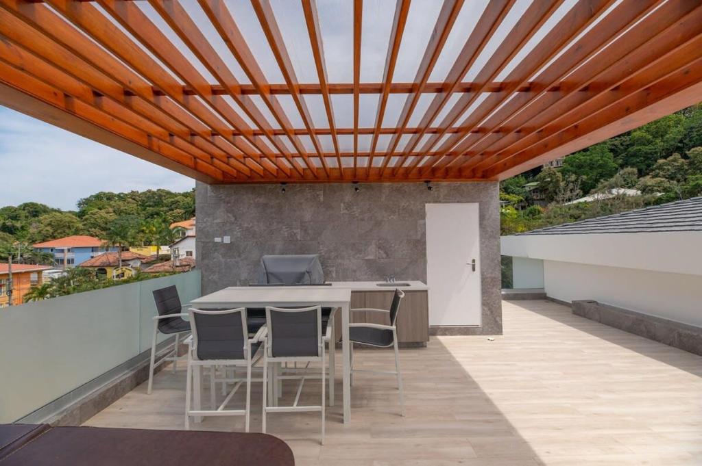 a wooden ceiling on a patio with a table and chairs at Marlin Villa #10 in West Bay
