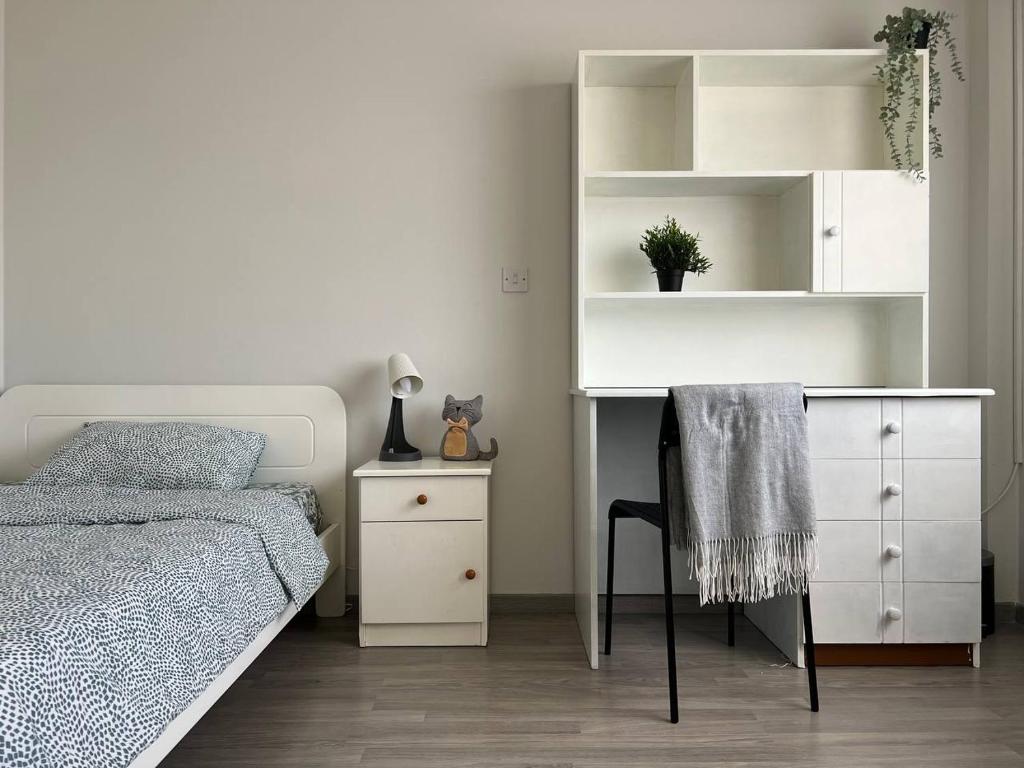 a bedroom with a bed and a desk and a chair at Quiet place in Limassol