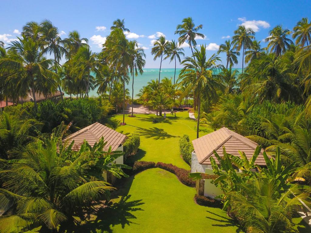 an aerial view of a resort with palm trees and the ocean at Pousada Samba Pa Ti in Pôrto de Pedras