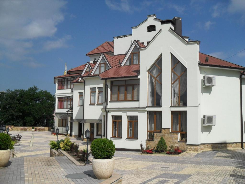 a large white building with a red roof at AlGrado Hotel in Kislovodsk
