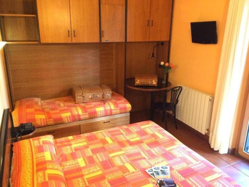 Łóżko lub łóżka w pokoju w obiekcie LH Albergo il Picchio