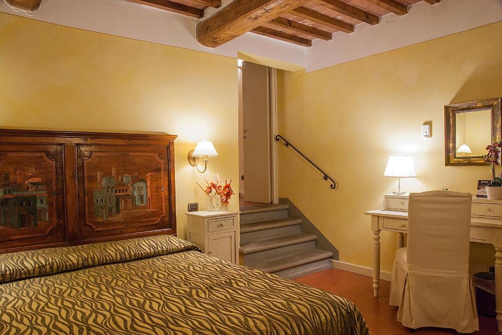 Postel nebo postele na pokoji v ubytování Borgo Sant'ippolito Country Hotel