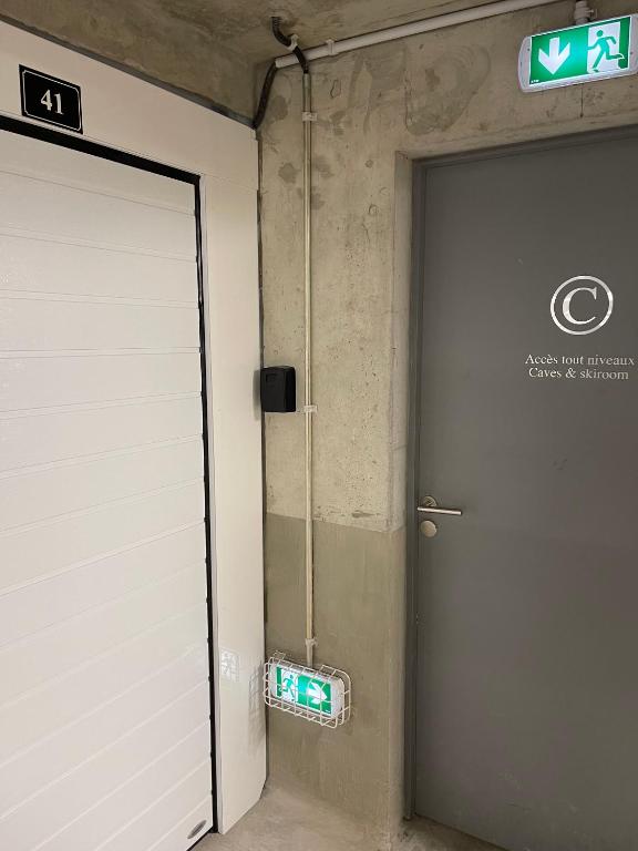 a door in a building with a sign next to it at GESPERE LE STELLA in Les Gets