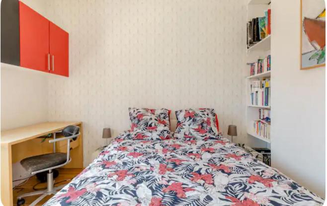 a bedroom with a bed and a desk and a book shelf at repiton preneuf in Annecy