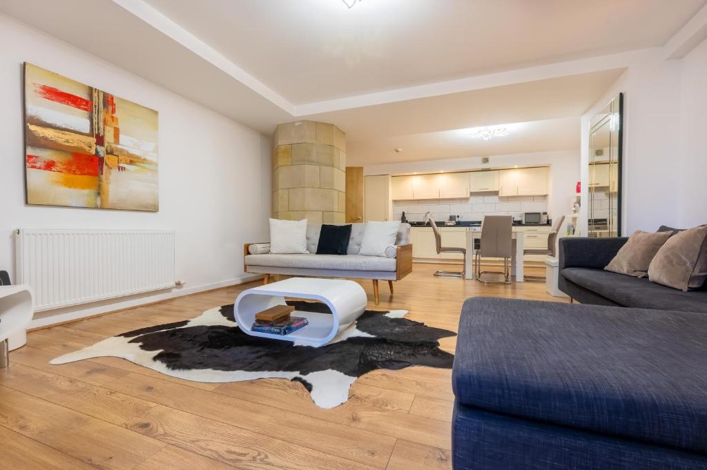 a living room with a couch and a table at AC19 Lower North Aisle - Luxury Self Catering 2 Bedroom Apartment in Fort Augustus