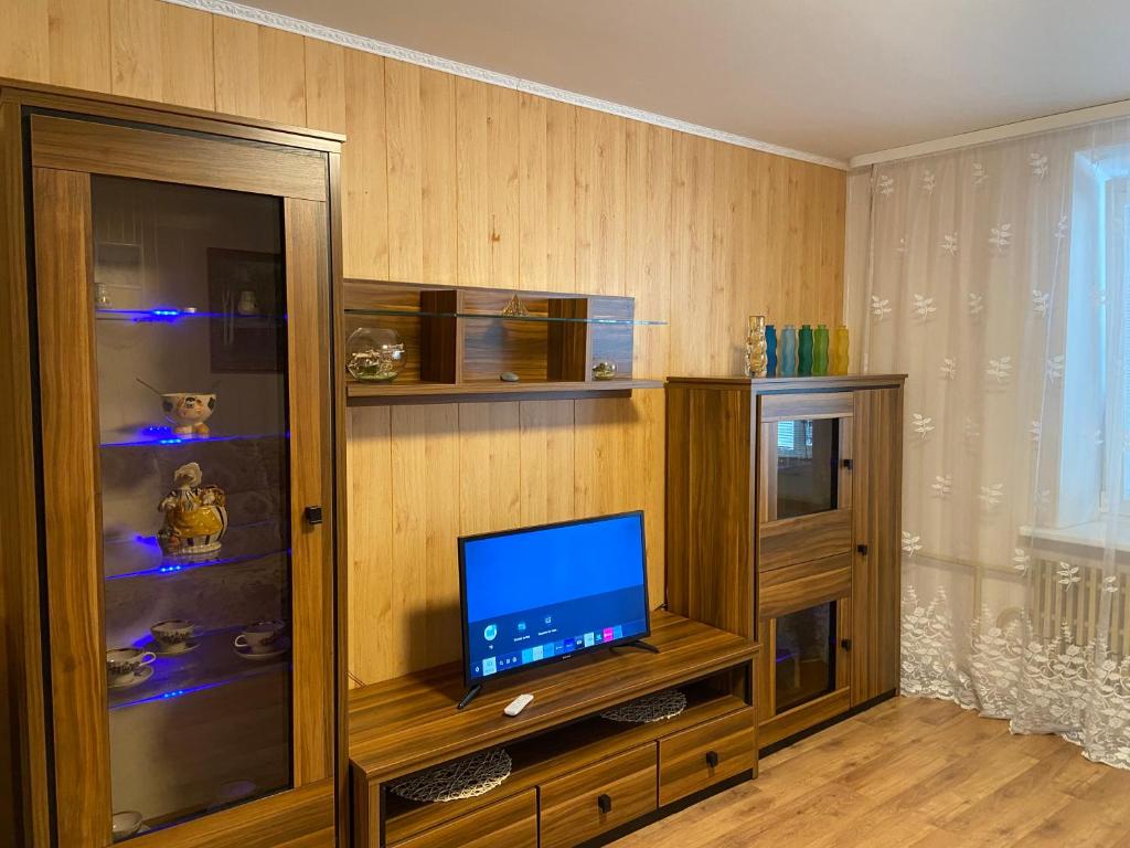 a living room with a tv and a entertainment center at Laguna in Visaginas