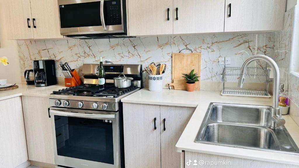 a kitchen with a stove and a sink at Mid-Century Modern Charm in Discovery Bay
