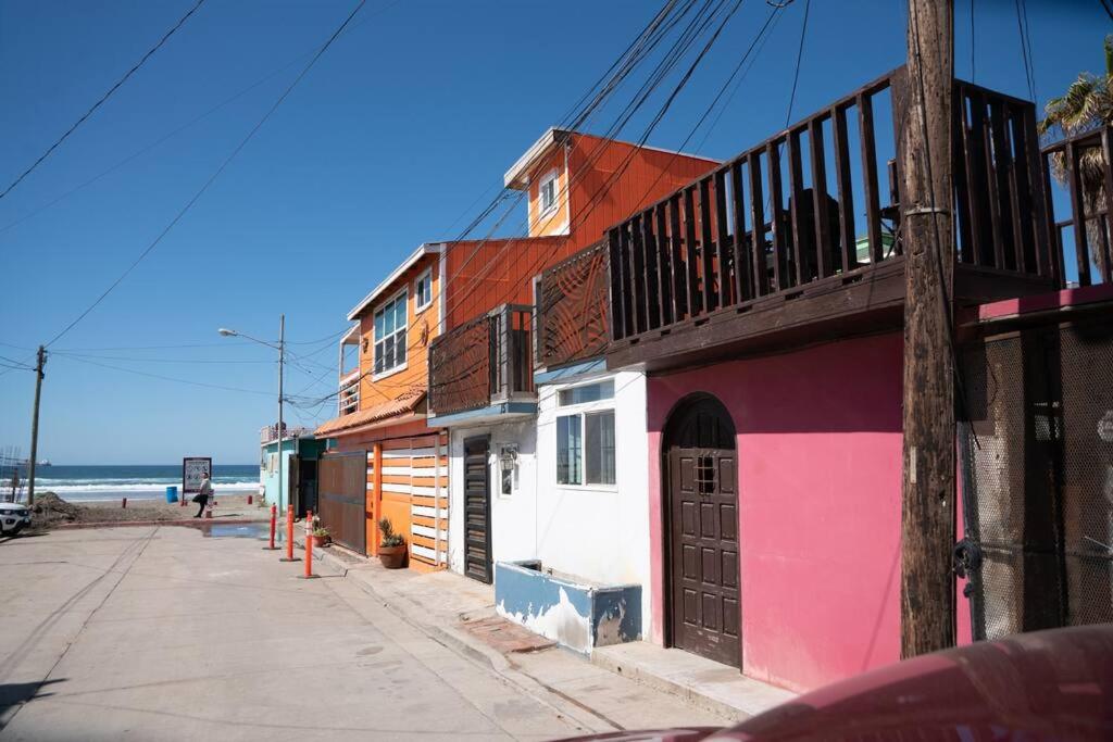 a row of buildings on a street next to the ocean at Be steps away from the beach - Downtown Rosarito in Rosarito