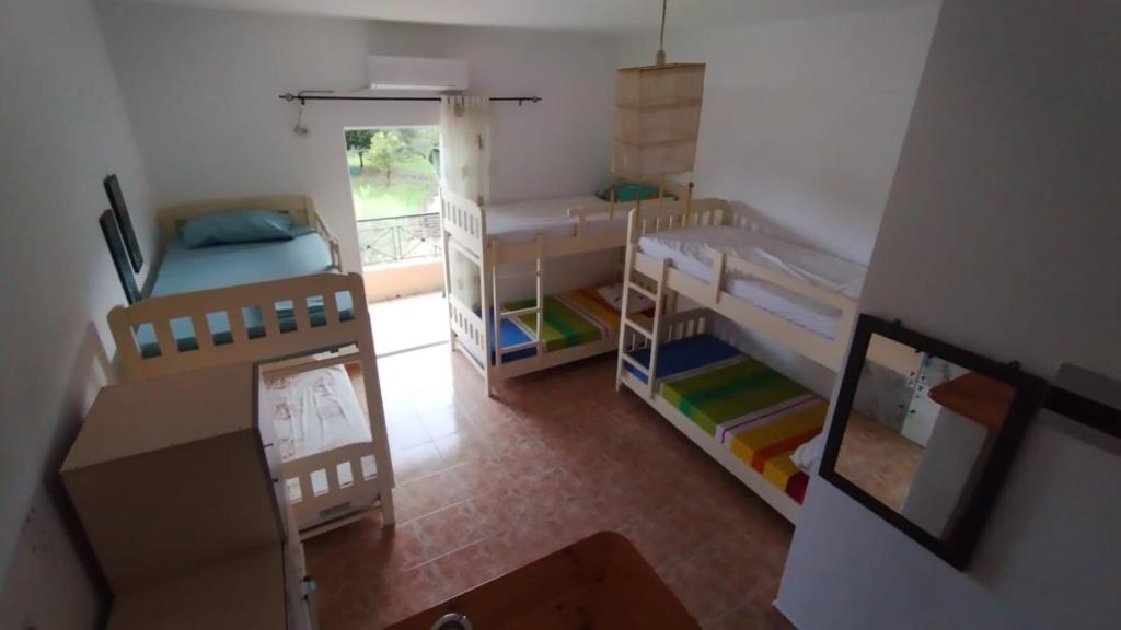 an overhead view of a room with bunk beds at Oasis Hostel in Himare