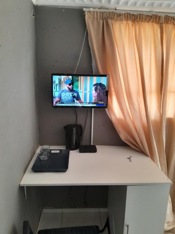 a computer monitor sitting on top of a desk at Letz Guest Lodge in Tolwe