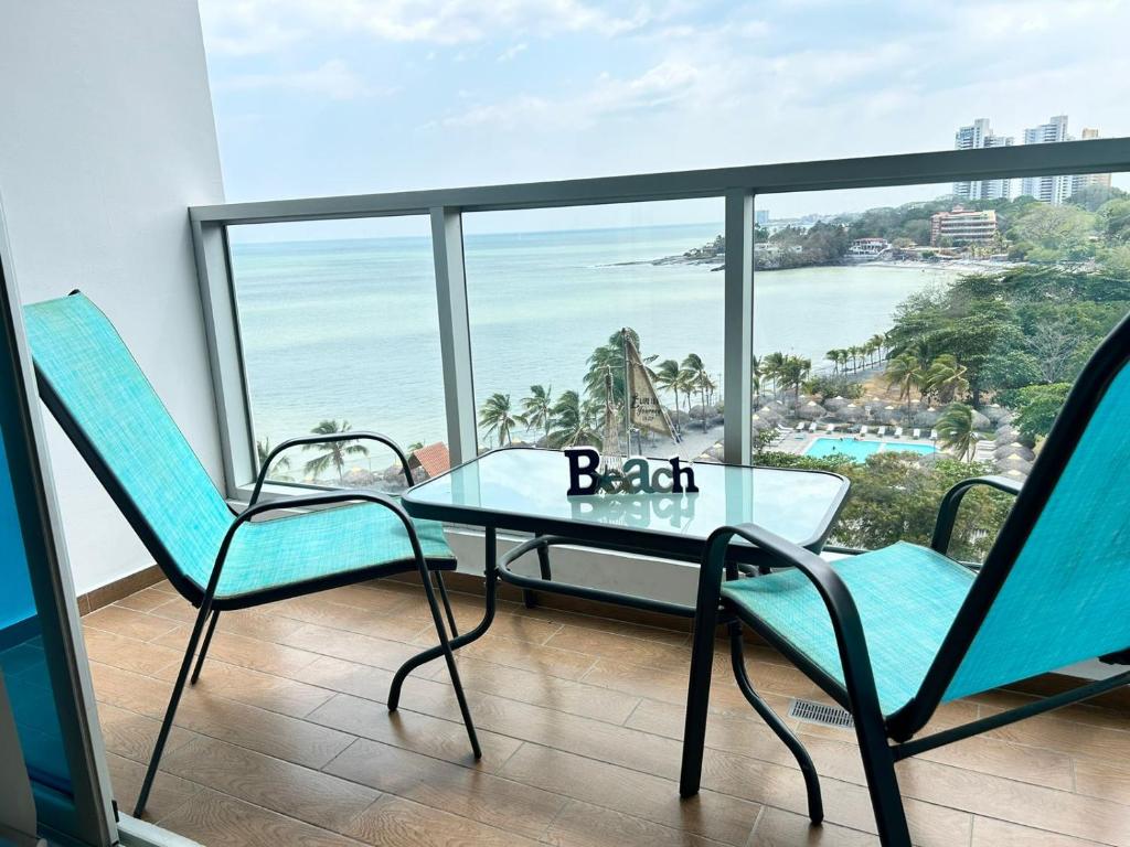 a table and chairs in a room with a view of the ocean at Condo Gorgona Beach Apartamento de Lujo de 2 Habitaciones in Chame