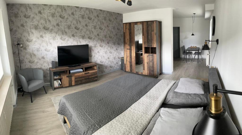 a bedroom with a bed and a flat screen tv at Ferienwohnung LauterWein in Bernkastel-Kues