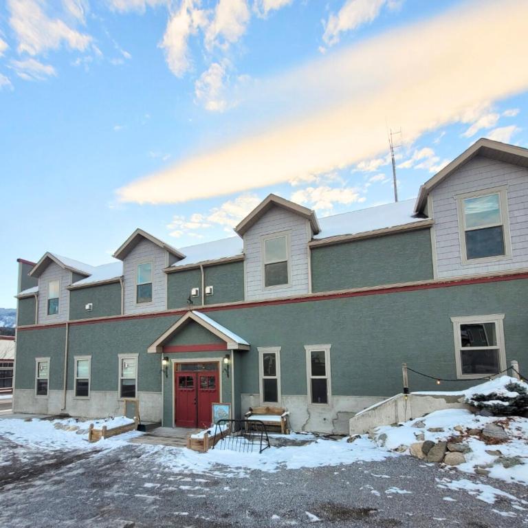 a large green building with a red door at Colemore Hotel in Coleman