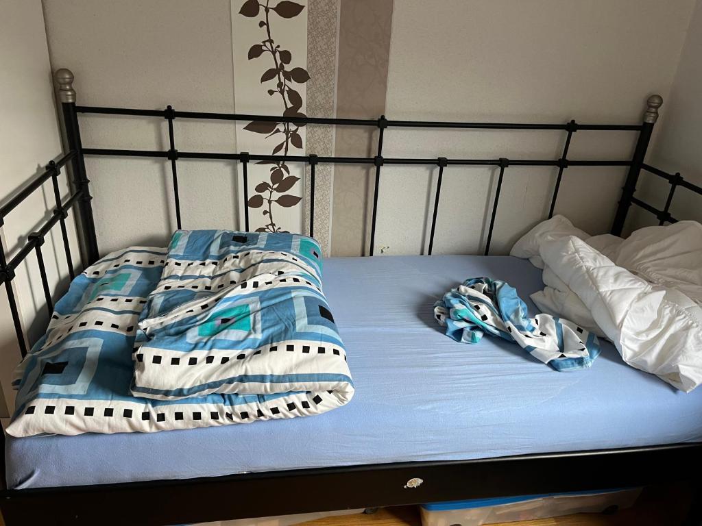 a bed with blue and white blankets and pillows at Monteurzimmer am Holzbach in Maroth