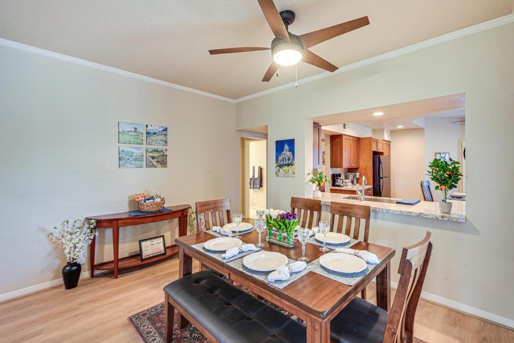 a dining room with a table and a ceiling fan at Palm Desert Condo with Patio and Community Perks! in Palm Desert