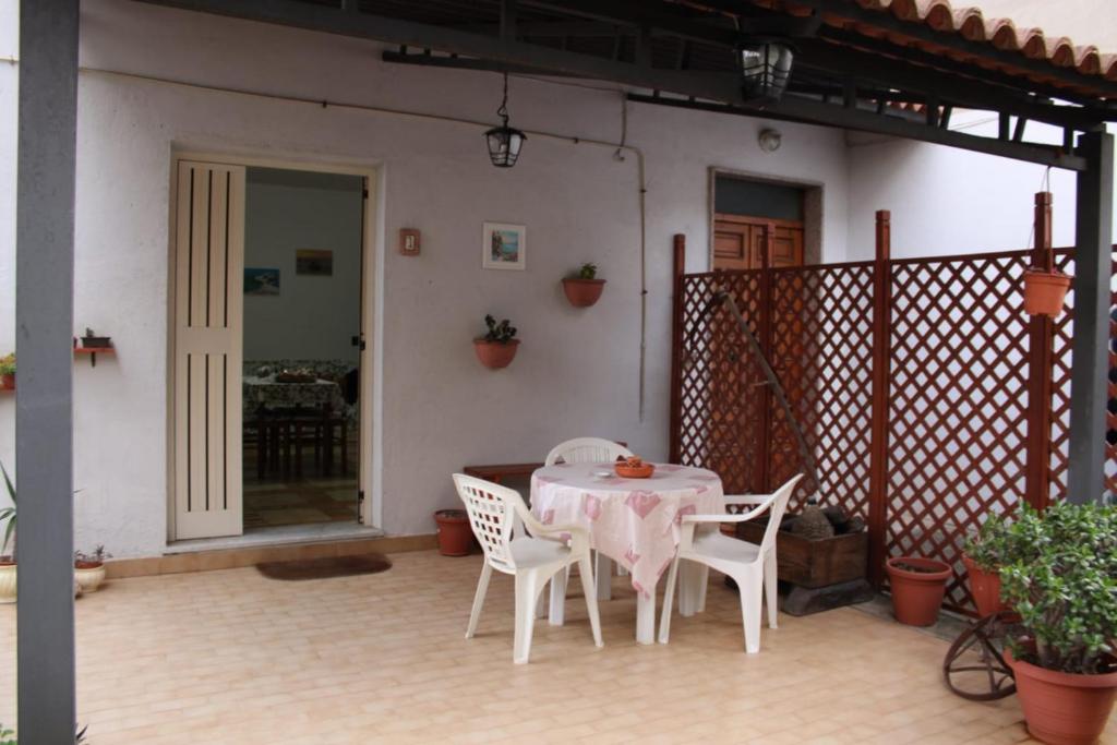 a table and chairs sitting on a patio at B&B La Petite Maison in Santa Domenica
