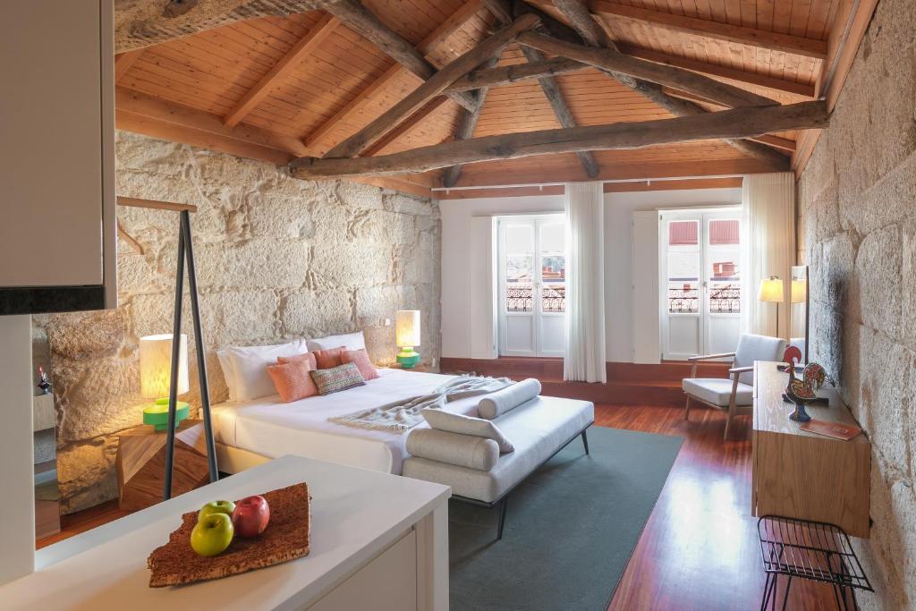 a bedroom with a bed and a living room at Bandeiras in Porto