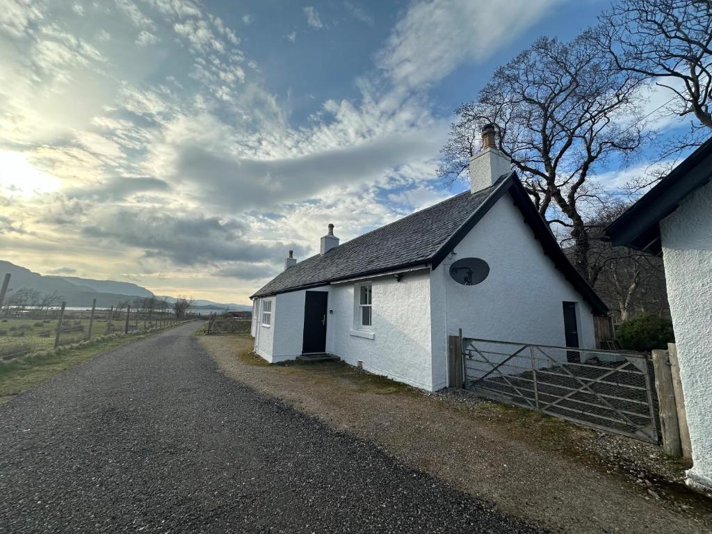 a small white chapel on the side of a road at Stalker's Cottage - Torridon in Achnasheen