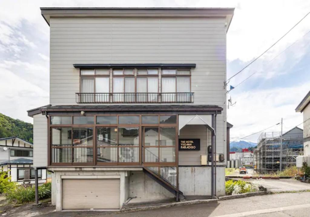 an apartment building with a balcony and a garage at Yuzawa Kodate - Vacation STAY 9495 in Yuzawa