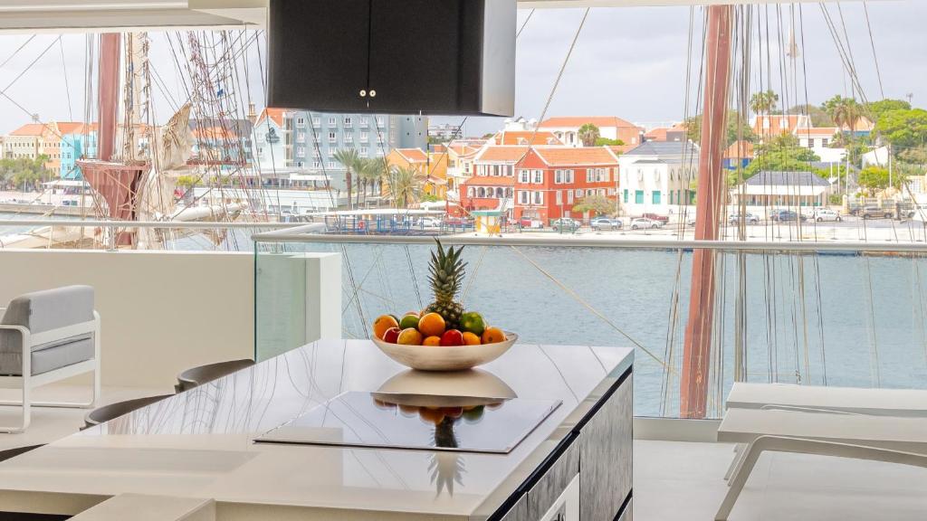 a bowl of fruit on a counter in a kitchen at The Wharf Luxury Apartment MT 7E in Willemstad
