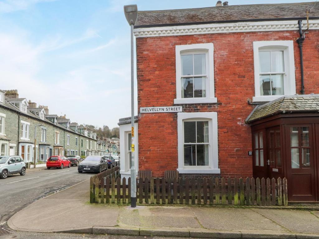 a red brick building with a street sign on it at Pelham House in Keswick