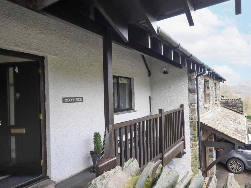 a house with a balcony with a sign on it at Beechside in Ambleside