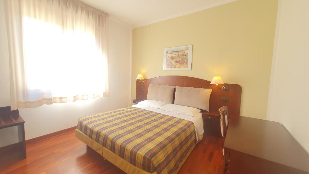 A bed or beds in a room at Agriturismo Gli Ulivi