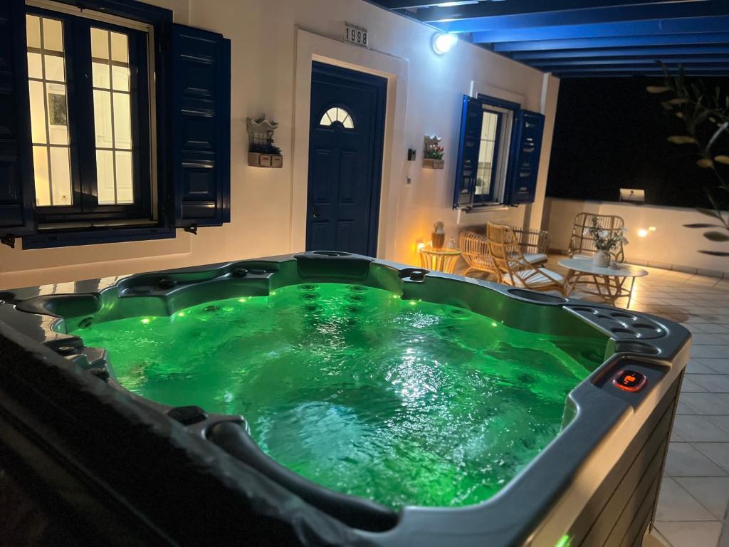 a large green bath tub in a house at Giannis & Maria Sunset House in Lagoúdi Zía