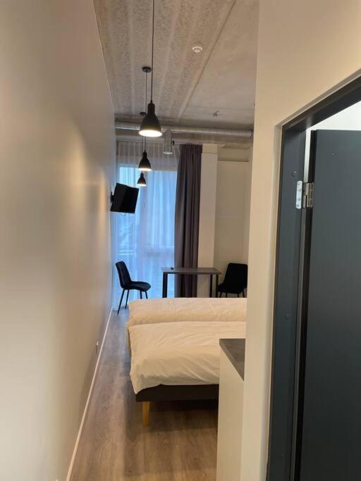 ein Schlafzimmer mit einem Bett und einem Tisch in einem Zimmer in der Unterkunft Apartment Loftas13-5 in Kretinga
