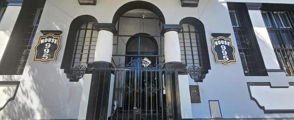 a front door of a building with black gates at Hostal House 995 in Santiago