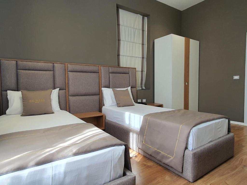 Postel nebo postele na pokoji v ubytování HEIRESS Hotel