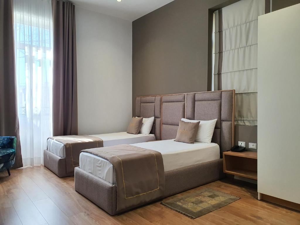 Postel nebo postele na pokoji v ubytování HEIRESS Hotel