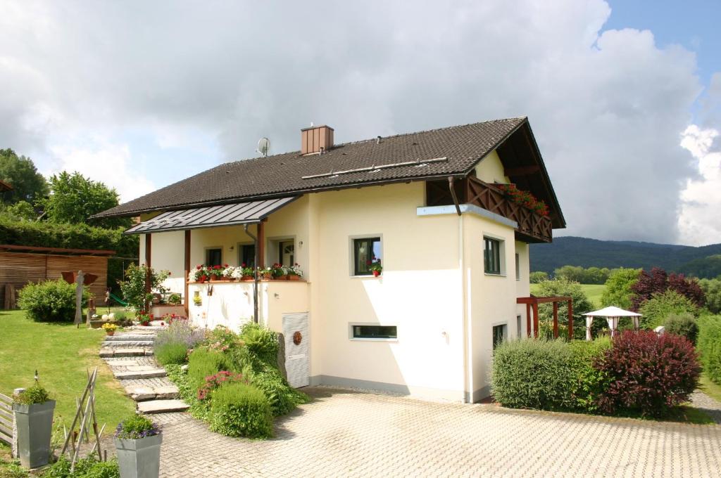 a white house with a black roof at Pension Hoisl in Schönberg