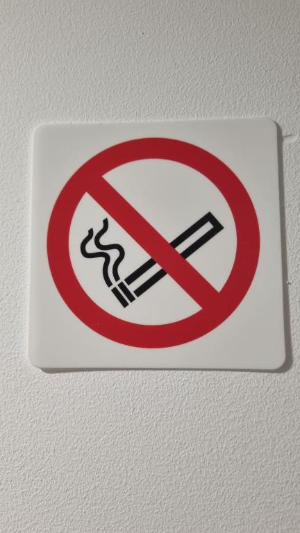 a no smoking sign on a wall at Katyto house in Costa da Caparica