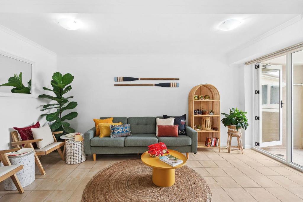 a living room with a couch and a table at The Lighthouse at Iluka Resort Apatments in Palm Beach