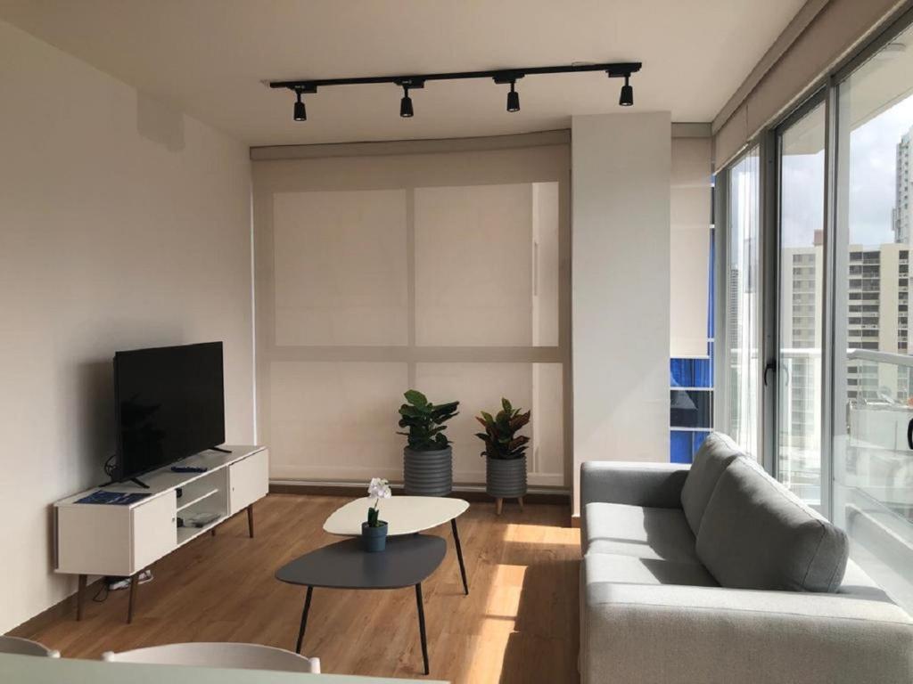 a living room with a couch and a tv at Impressive City View Apartment A - PH Quartier Marbella in Panama City