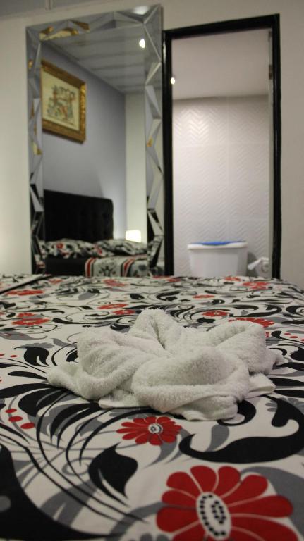 Postel nebo postele na pokoji v ubytování Hostal Queens Deluxe